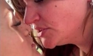 Close up POV of real lesbian couple kissing