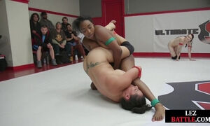 Lesbian Black and white wrestlers wrestling in public